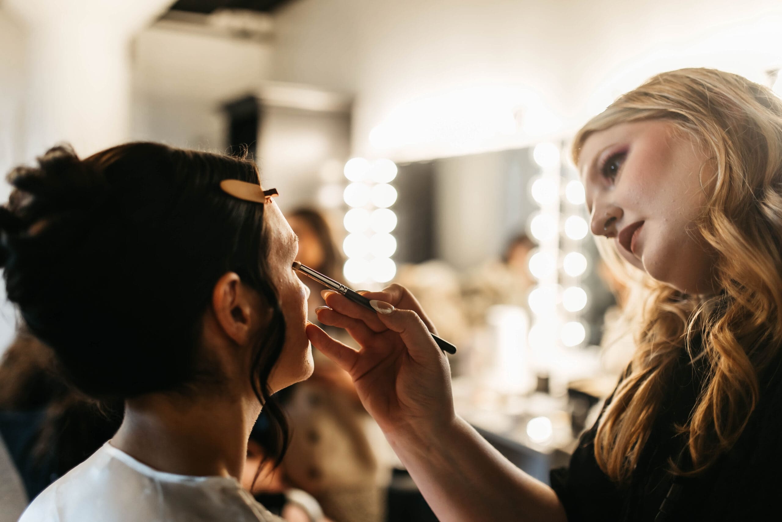 Wedding hair and makeup team providing services to a bridal party on the wedding morning