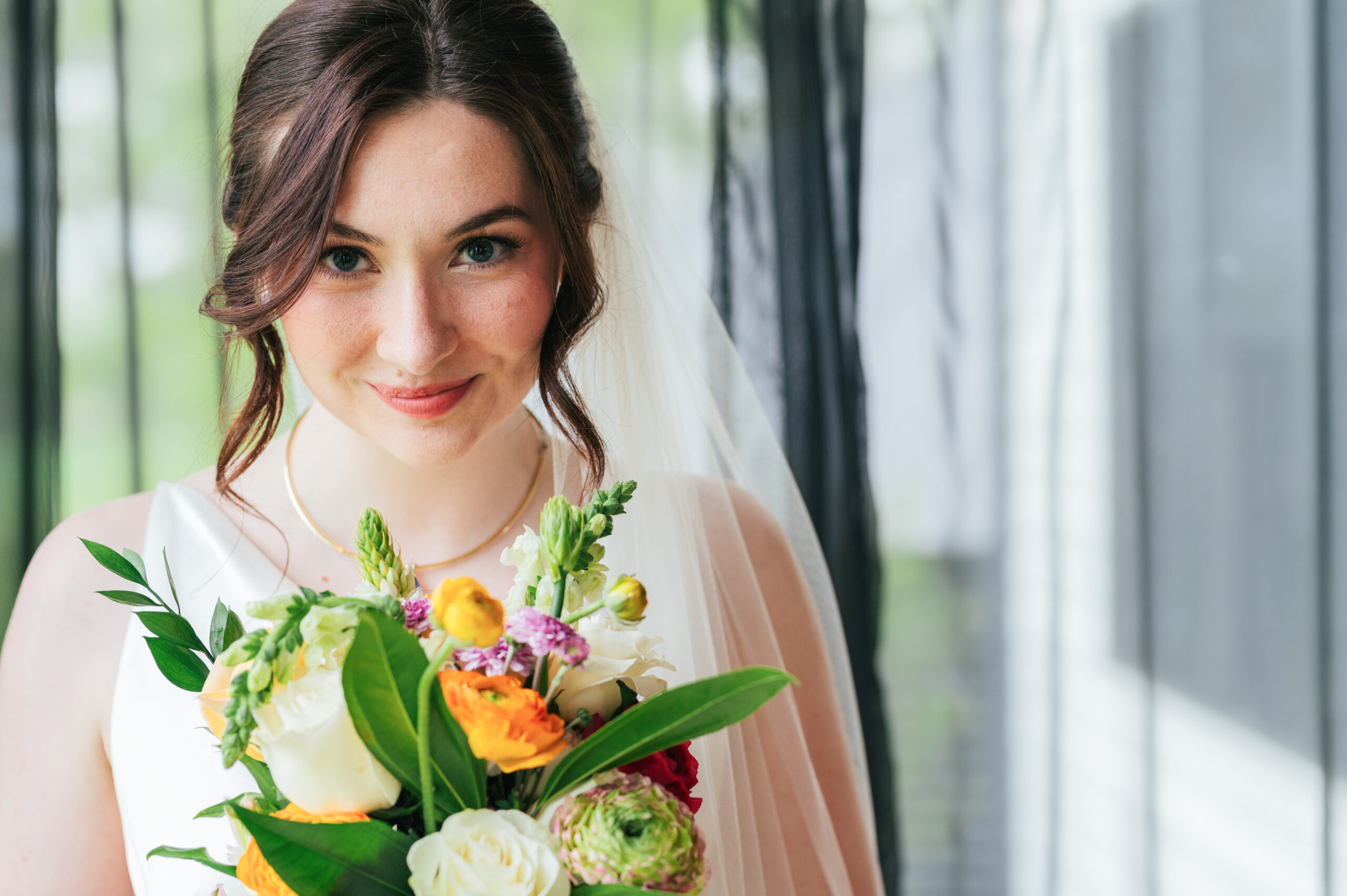 Professional bridal hair and makeup team preparing a bride for her wedding day.